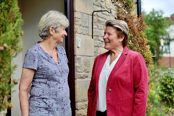 Sarah Dyke speaks to a woman on a doorstep